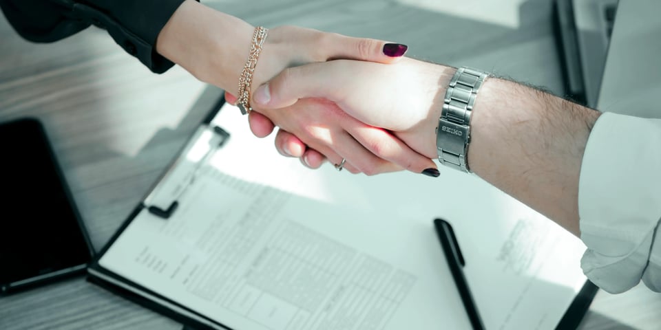 Personas estrechando la mano. Crédito bancario: Beneficios y contras de pedir uno