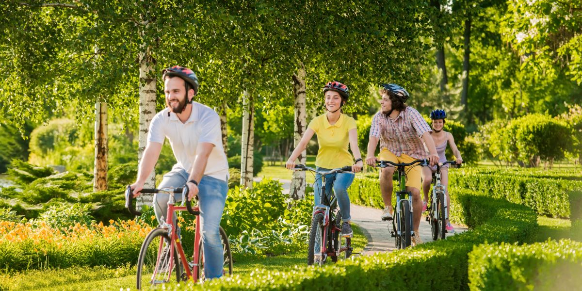 Grupo de adultos y jóvenes están paseando en bicicleta al aire libre. 