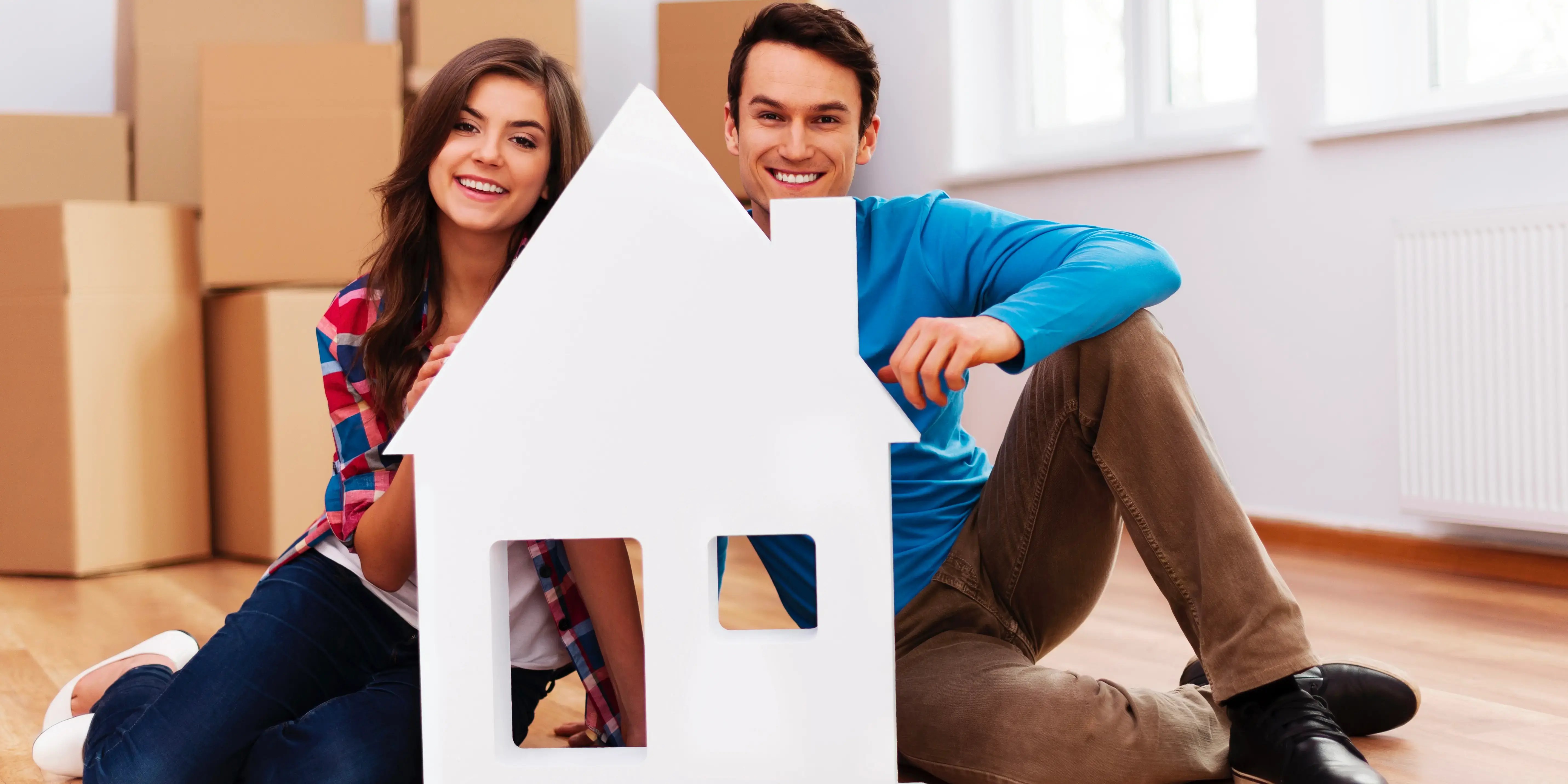 young-couple-with-house-sign